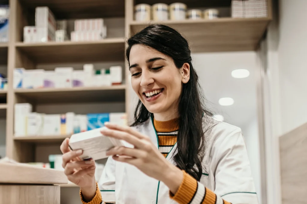 Pharmacist reading the label on a medication box