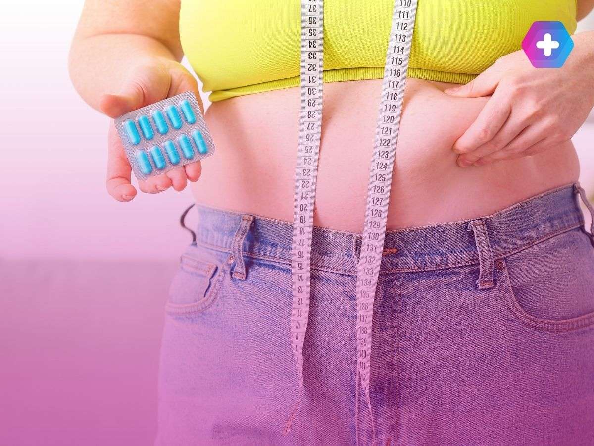 woman in workout top and jeans holding weight loss pills