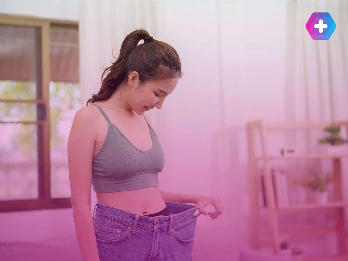 woman in green crop top wearing jeans too big