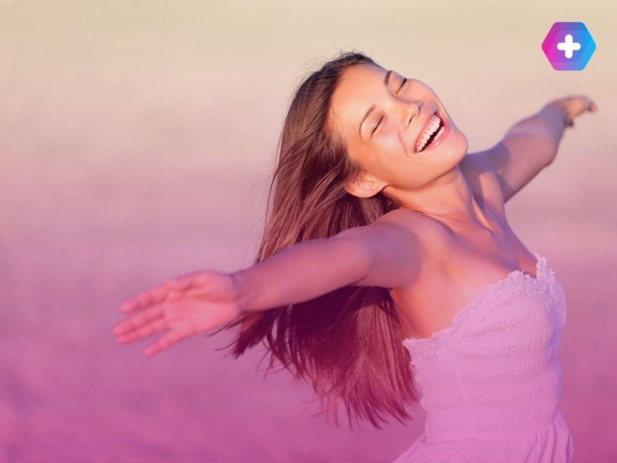happy woman wearing white dress on beach