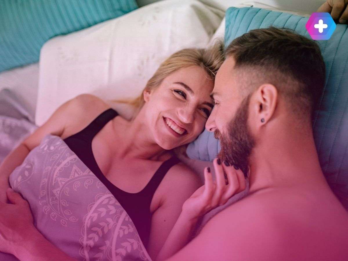 happy couple smiling in bed