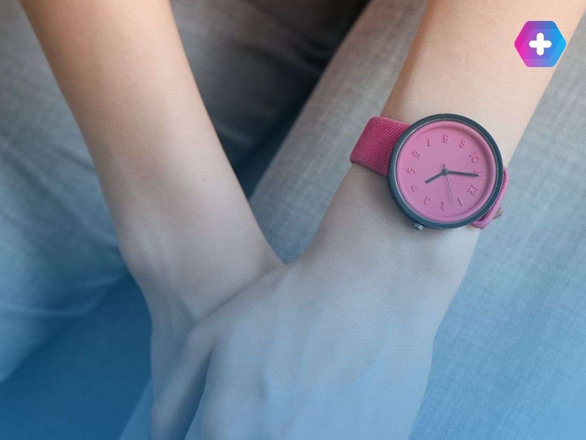 Woman checking the time to take period delay tablets