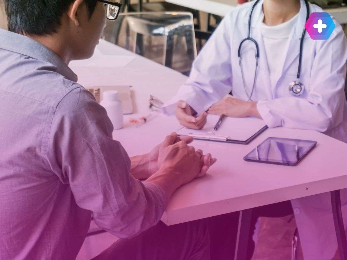 male patient speaking to doctor at table
