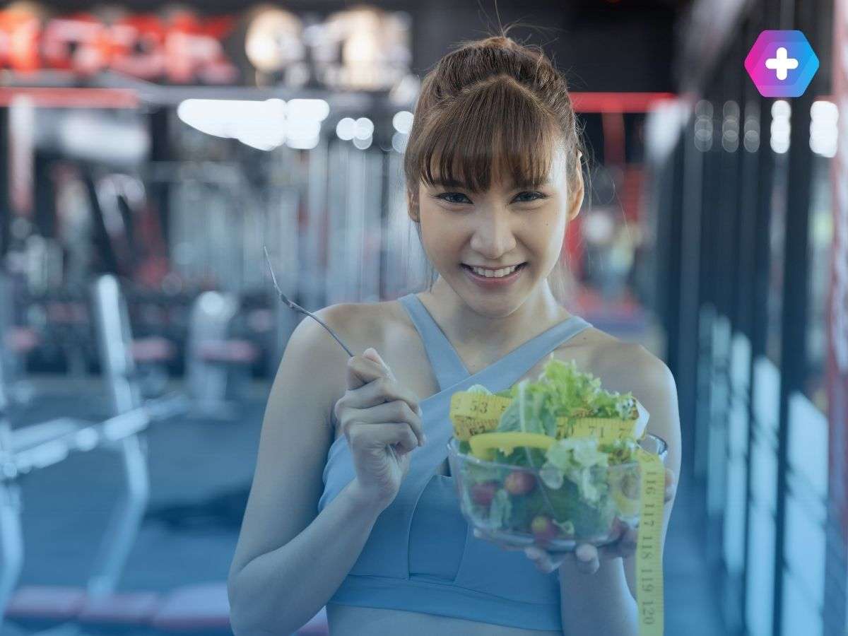 Woman healthy eating in a gym