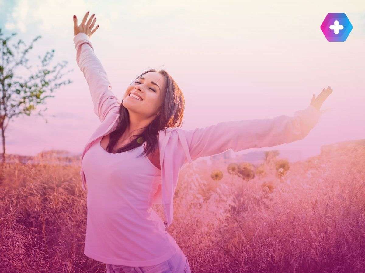 woman smiling in field outdoors