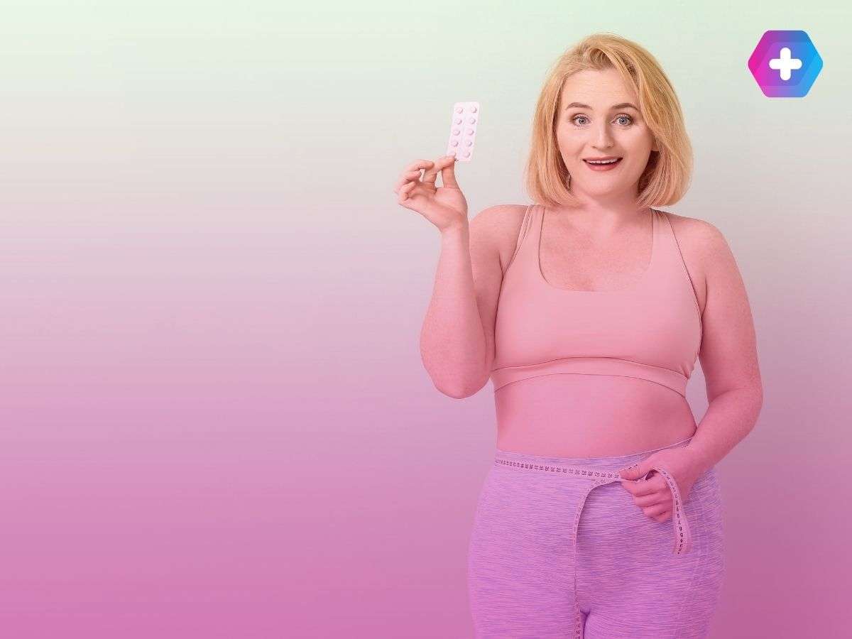 young woman measuring waist holding weight loss pills