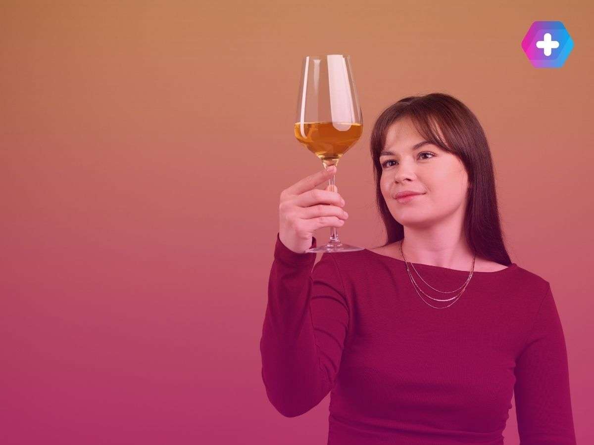 woman in red top holding glass of wine
