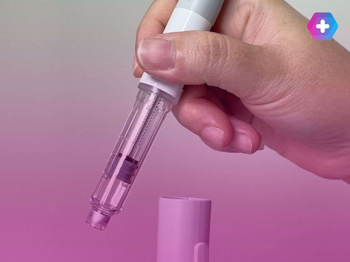 person removing weight loss injection from cap