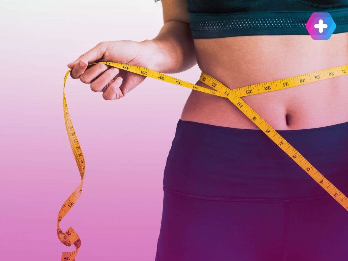 woman in workout gear measuring waist