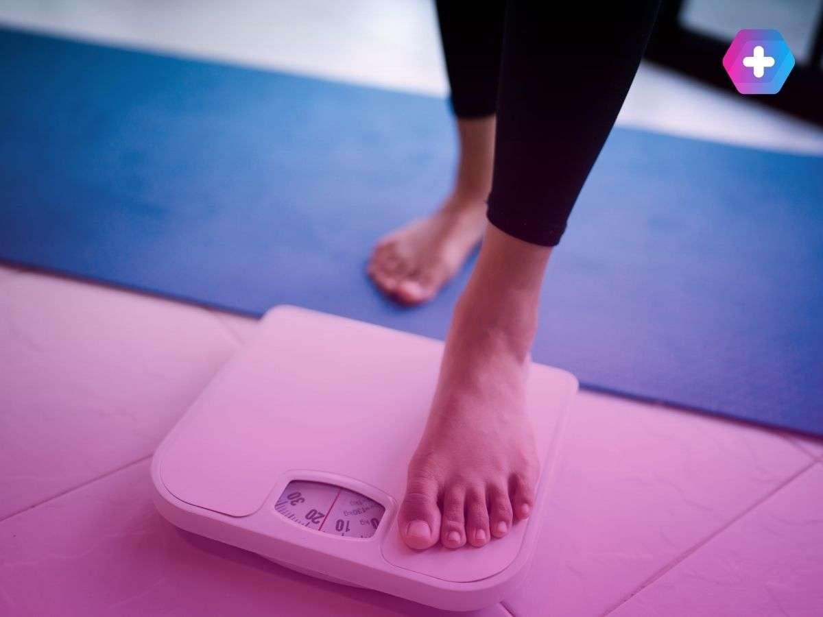 person in bare feet stepping on scales