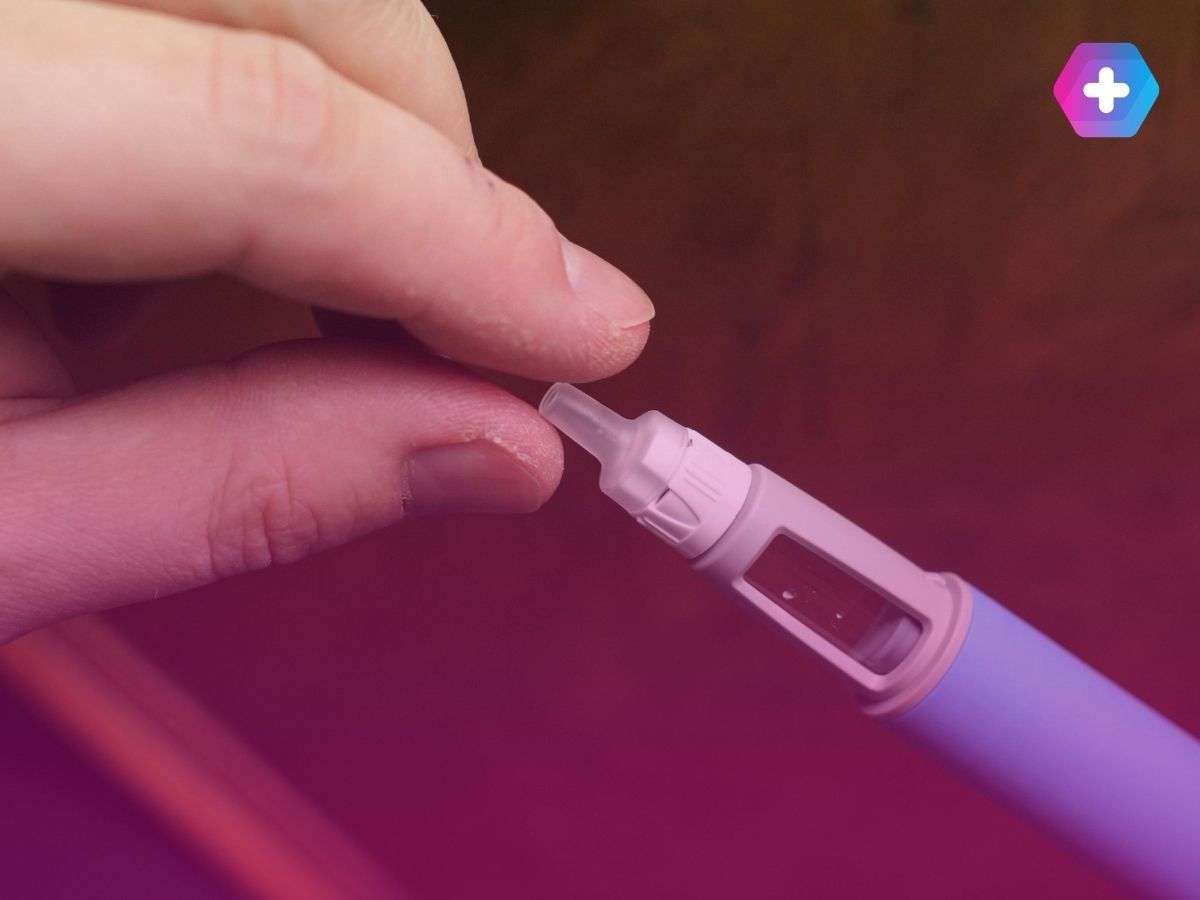 close-up of person holding weight loss injection