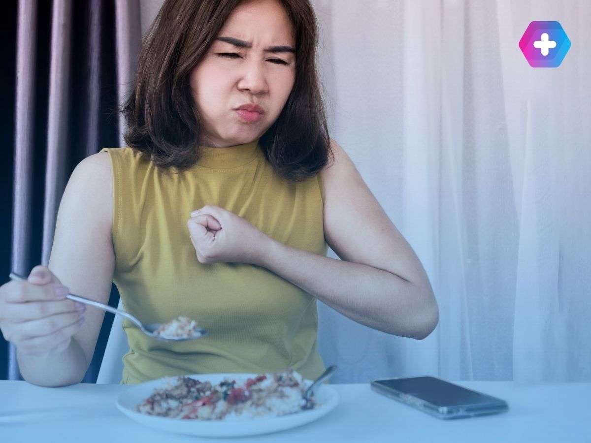 Woman eating food and struggling with acid reflux